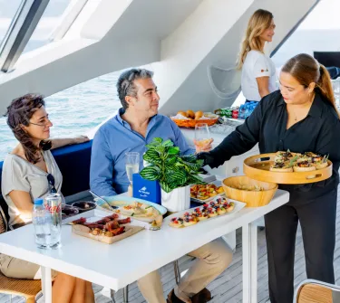 Visitors enjoying a dining cruise package on a Dubai yacht