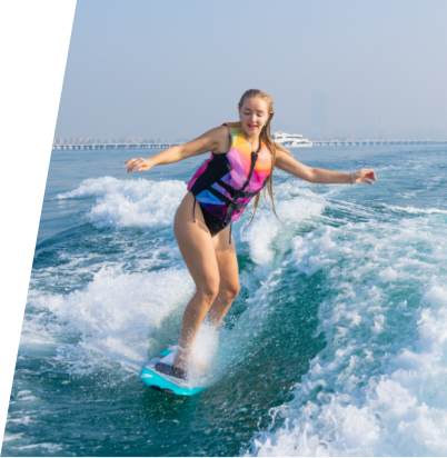 Beautiful women enjoy wakesurfing in the sea
